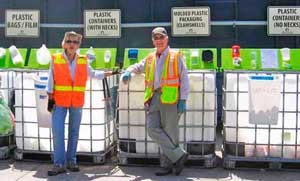 Volunteers Julie Van Camp and Mac Langford stand by at the recycle component of the award-winning Lopez Solid Waste Disposal District