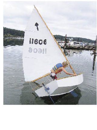 Adventurous young sailor prepares for capsize maneuvers during Lopez Summer Sailing Workshop