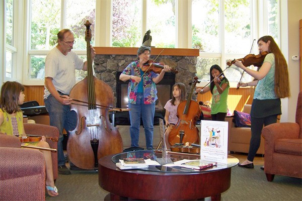 A string ensemble by the fireplace.