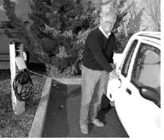 OPALCO member Bill Wulff charges his electric car at the new ChargePoint station behind Orcas Island Market.