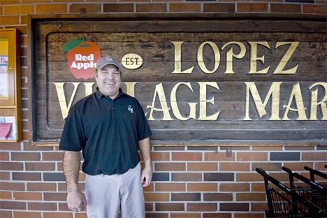 Market manager Aaron Dye in front of the current village market. “We’re keeping the sign