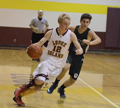 Fletcher Moore drives to the basket against a Lion defender in the Lobos 63-46 loss to Cedar Park.