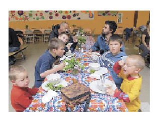 Lopez children and parents enjoy family-friendly food at one of last year’s Evening Meals.