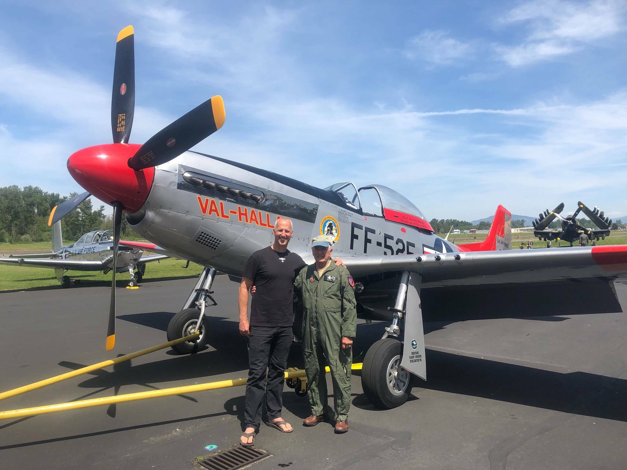 Bill Anders (right) with SeaDoc Society Chief Scientist Joe Gaydos in 2019 after Bill and his wife Valerie surprised the nonprofit with a $50,000 donation to support Salish Sea research. The two are pictured with Bill’s vintage P-51 Mustang aircraft.