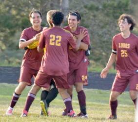 Contributed photo
Jubilant Lopez soccer players (left to right: Rafa Velazquez, Uli Velazquez, Nikolai Kazakov and Rowdy Spreine) mob keeper Jacob Sanford after the Lobos’ historic 2-1 victory over Friday Harbor, Sept. 20th.