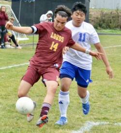 Co-captain Rafa Velazquez fights off a Grace Academy defender in the Lobos’ 5-0 win against the Eagles at home on Oct. 1.
Contributed photo by Gene Helfman