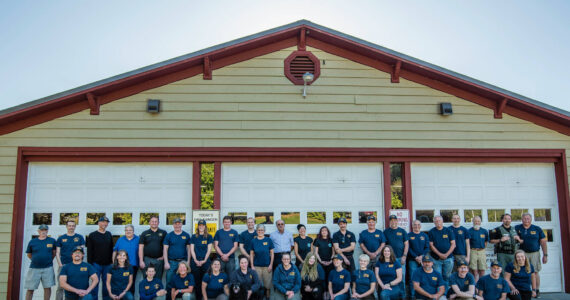 Robert Harrison photo
Back row, left to right: Basil Gunn (logistics) Andrew Robin (former EMT), Duane Bordvick (commissioner), Becky Smith (commissioner), Adam Bigby (fire Chief), Mike Reinmuth (ff), Mariah Honeywell (ff), Caleb Pal (captain paramedic), David Rucker (FD/EMT), Bo Walker (ff), Richard Tetú, (ff lieutenant), Ronni Klompus (EMT), Renee Koplan (EMT), Dave Hellman (ff), Page Reed (Logistics), Ken Aufderhar (Logistics), Monte Midkiff (logistics Lieutenant), Jim Ghiglione (former logistics), Justin Hagge (ff/EMT), Corky Searls (Logistics), Sam Fowler (ff/EMT), Rob Nou (ff/Lieutenant). Bottom row, left to right: JK Honeywell (ff/Lieutenant), Kim Herrenkohl (retired Administrative assistant), Chelsea Avery (EMT), Donna Hasbrouck (EMT), Audrey Wakefield (Logistics), Nicole O’Bryant (Captain Paramedic), Mose (a good boy), Michelle Mcdarmont (Captain Paramedic), Emma Hatchel (former EMS student), Megan Crandell (EMT), Oliver Henderson (former ff), Aimee Stephens (former ff/EMT), Monico Mackinnon (ff lieutenant/EMT), Joel Ray (former firefighter), Brian Silverstein (logistics), Emma Ewert (EMT). Not all volunteers are pictured here.