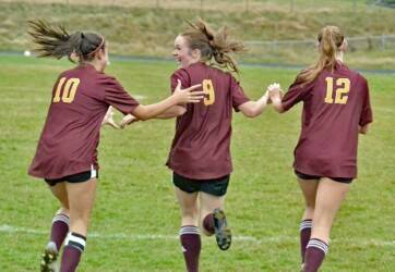 Glory Westervelt (10) and Iris Ervin-McLean (12) celebrate Lilly Nichols’ (9) goal in the first period of the Lobos’ 2-1 loss to Friday Harbor, Oct. 14.
Contributed photo by Gene Helfman