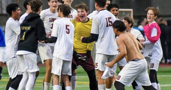 Contributed photo by Kaileah Poole
Jubilant Lopez players celebrate their 1-0 district championship win against Orcas High on Nov. 9th. The win qualified the Lobos for the quarter-finals of the state championship. Stay tuned.