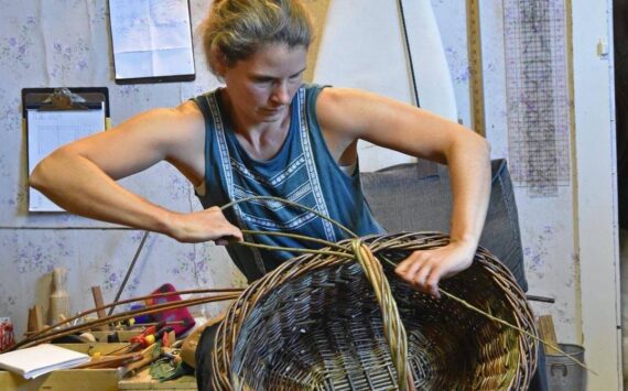 Maria Bullock weaving a basket.